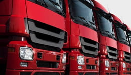 Frota de caminhões vermelhos em diagonal ilustrando o uso de lubrificantes Mobil para serviço pesado